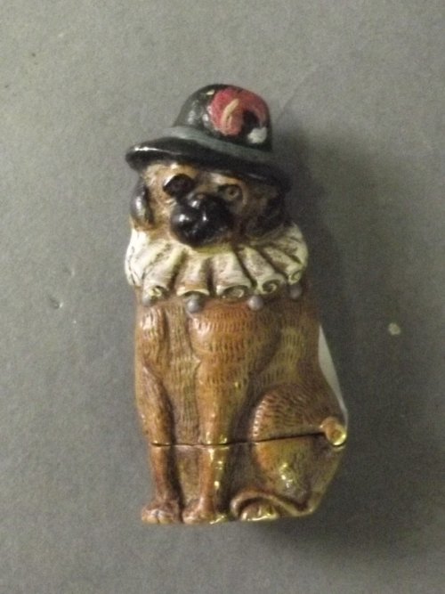 A cold painted brass vesta in the form of a seated dog,: A cold painted brass vesta in the form of a seated dog, 2¼'' long