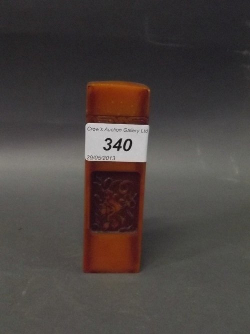 A Chinese orange soapstone seal with inscriptions and