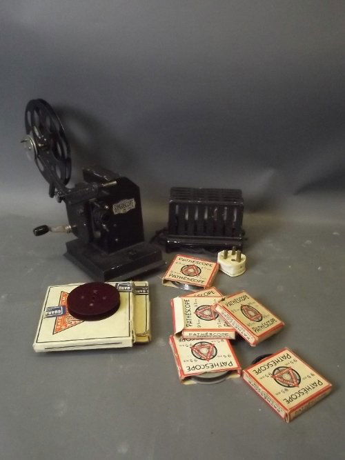 A Bingoscope projector and a quantity of 9.5mm films: A Bingoscope projector and a quantity of 9.5mm films including 'Wooden Soldiers', 'Chapter of Accidents', and Donald Duck's debut