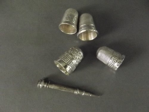 Four Hallmarked silver thimbles and a Hallmarked silver