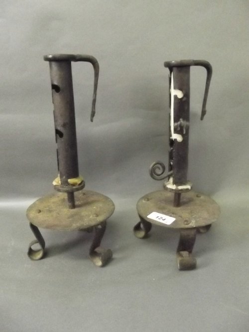 A pair of antique wrought iron ejector candlesticks on 