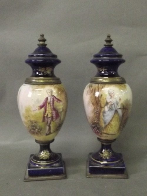 A pair of signed French porcelain vases on square bases: A pair of signed French porcelain vases on square bases painted with a man and woman in classical dress sitting in a garden (1 AF), 7'' high