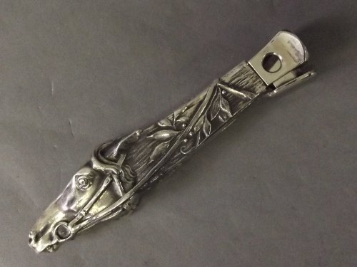 A silver plated cigar cutter in the form of a racing ho: A silver plated cigar cutter in the form of a racing horse, 6'' long