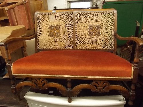 A 1930s bergere beech framed 2 seater settee with carve