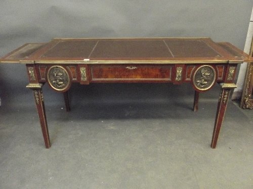 A French Louis XV style walnut and kingwood bureau plat: A French Louis XV style walnut and kingwood bureau plat, with a leather inset top and ornate brass mounts, 61'' x 29½'', 30'' high