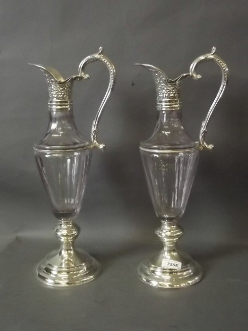 A pair of amethyst glass ewers with silver plated: A pair of amethyst glass ewers with silver plated mounts, 18'' high