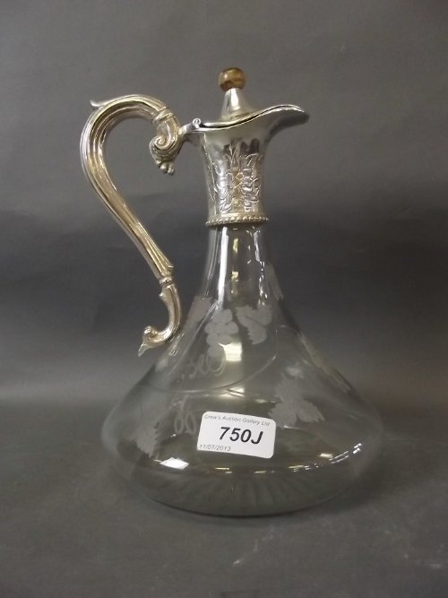 A cut glass and silver plated wine ewer with etched: A cut glass and silver plated wine ewer with etched grape and vine decoration, 10'' high