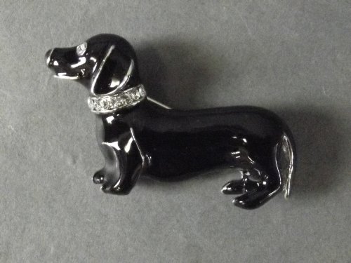 A black enamel brooch in the form of a Dachshund: A black enamel brooch in the form of a Dachshund wearing a stone set collar, 1½'' long