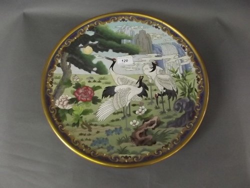 A large oriental cloisonné charger decorated with: A large oriental cloisonné charger decorated with storks in a landscape, 15¼'' diameter