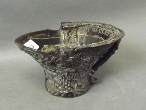 A carved horn libation cup with raised immortals, bats: A carved horn libation cup with raised immortals, bats and landscape scenes to the exterior, 4¼'' high