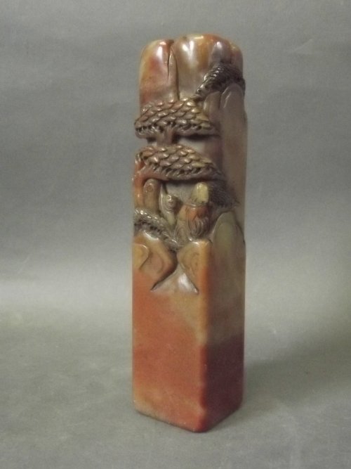 A large Chinese soapstone carved with figures in a: A large Chinese soapstone carved with figures in a rocky landscape, with calligraphy to the side, 6½'' x 1½'' x 1½''