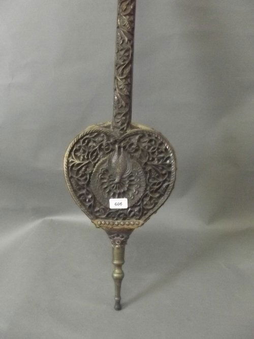 An Indian C19th carved hardwood bellows decorated with: An Indian C19th carved hardwood bellows decorated with a peacock and floral design, 40'' long (AF)