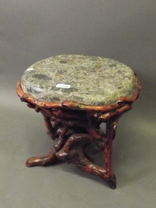 A Chinese root wood stool with an inset solid stone: A Chinese root wood stool with an inset solid stone top, 14'' x 15''