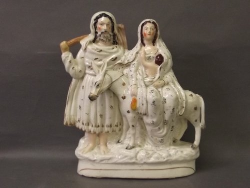 A Staffordshire white and gilt group of Flight to Egypt: A Staffordshire white and gilt group of Flight to Egypt depicting Mary riding on a donkey being led by Joseph, 11'' high