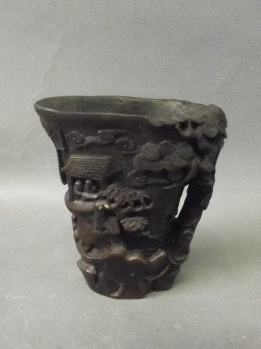 A Chinese carved composite cup with figures in: A Chinese carved composite cup with figures in landscape scenes to sides, 4'' high