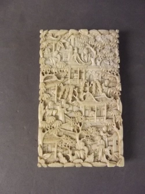 A C19th Chinese Cantonese carved ivory card case: A C19th Chinese Cantonese carved ivory card case decorated with figures, pavilions etc, 3¾'' x 2¼''