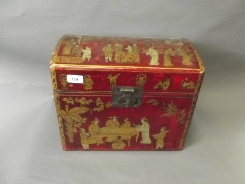 A Chinese dome topped red lacquer casket decorated with: A Chinese dome topped red lacquer casket decorated with chinoiserie scenes, with brass mounts, 15'' wide, 12½'' high