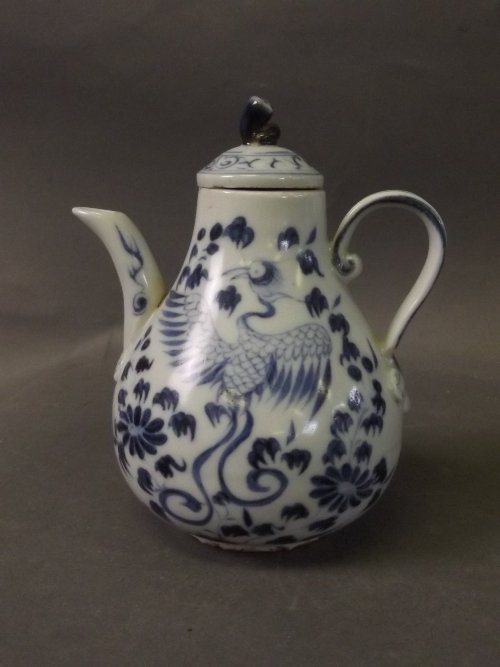 A Chinese blue and white teapot decorated with a: A Chinese blue and white teapot decorated with a phoenix and flowers, 3'' high