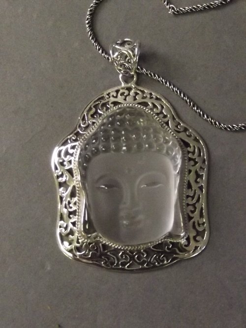 A silver and carved glass Buddha necklace, 18'' long: A silver and carved glass Buddha necklace, 18'' long