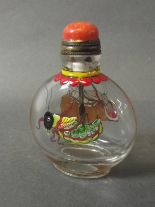 A Chinese glass snuff bottle with painted enamel: A Chinese glass snuff bottle with painted enamel decoration of crickets to sides, character signature to base, 2¾'' high