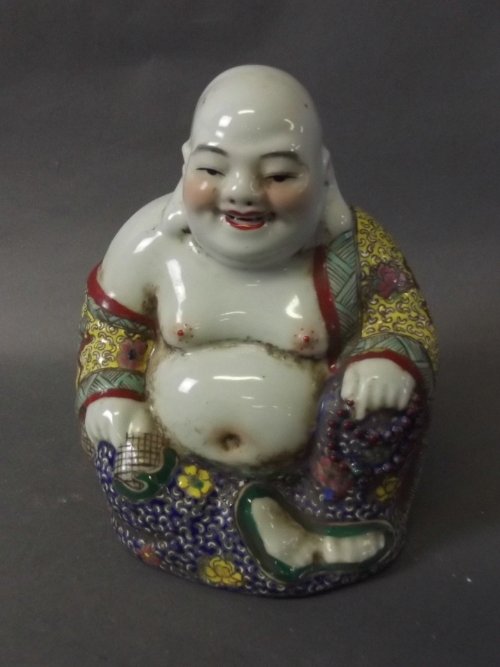 A Chinese pottery seated Buddha with applied polychrome: A Chinese pottery seated Buddha with applied polychrome enamel decoration, impressed mark to base, 6½'' high