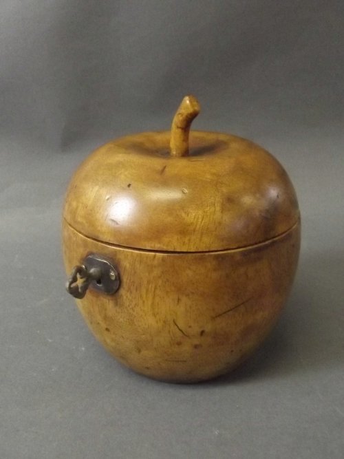 A treen tea caddy in the form of an apple, 4¾'' high: A treen tea caddy in the form of an apple, 4¾'' high