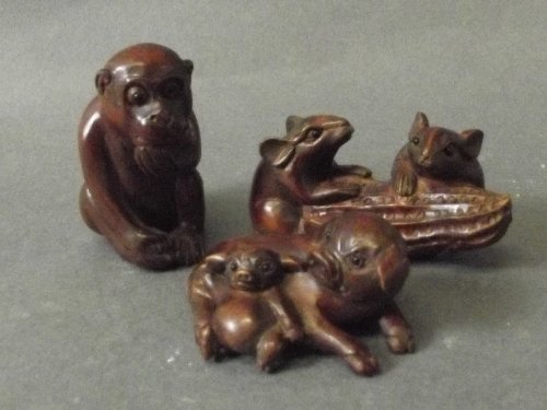Three hardwood netsuke in the form of a seated monkey,: Three hardwood netsuke in the form of a seated monkey, a pig and piglet, and 2 mice with a peanut, 2½'' long