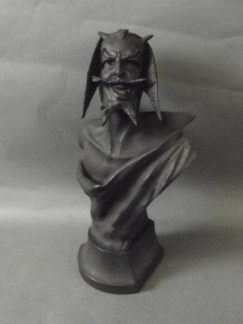 A cast iron bust of a bearded man by Morelli, signed: A cast iron bust of a bearded man by Morelli, signed and dated 1895, 11'' high