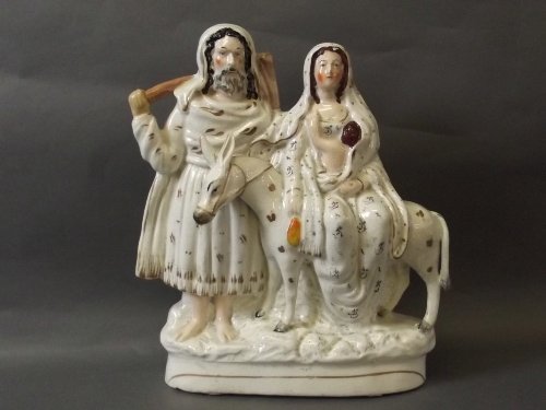 A Staffordshire white and gilt group of Flight to Egypt: A Staffordshire white and gilt group of Flight to Egypt depicting Mary riding on a donkey being led by Joseph, 11'' high