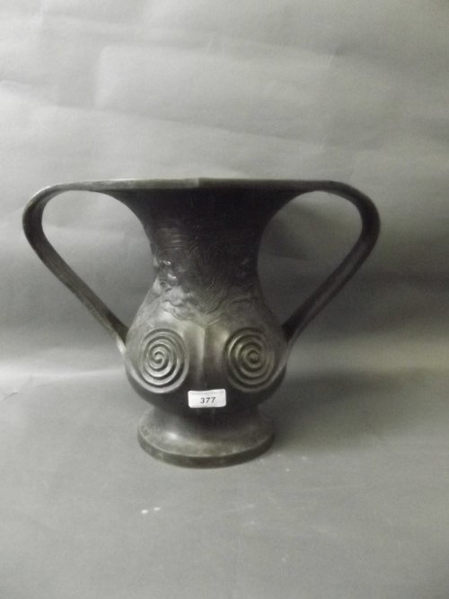 An unusual C19th Japanese twin handled bronze vase with: An unusual C19th Japanese twin handled bronze vase with stylized decoration, 12'' high
