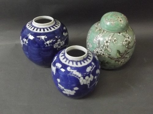 Two Chinese blue and white ginger jars with cherry: Two Chinese blue and white ginger jars with cherry blossom on cracked ice decoration, and one other green ground ginger jar and cover, character marks to base, 5¾'' high