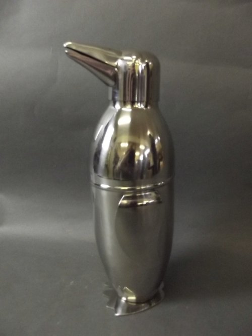 A silver plated cocktail shaker in the form of a: A silver plated cocktail shaker in the form of a penguin, 9'' high