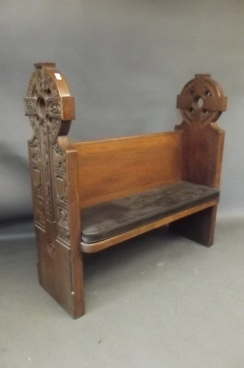 A good C19th Irish carved oak pew, the ends in the form: A good C19th Irish carved oak pew, the ends in the form of Celtic crosses, 50½'' wide
