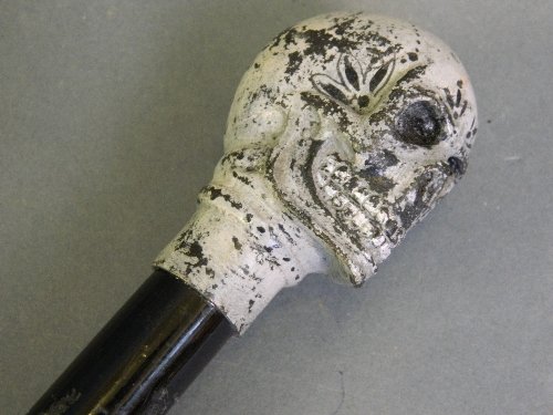 A walking stick with a cold painted bronze skull to: A walking stick with a cold painted bronze skull to end, 36'' long