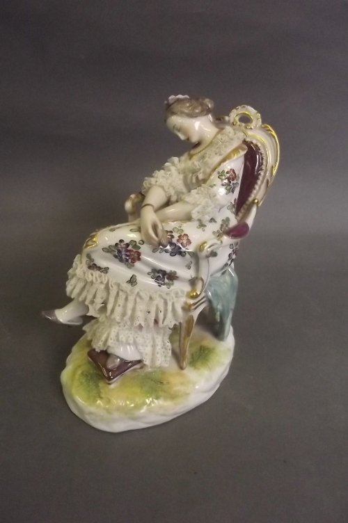 A C19th German porcelain figure of a maiden sleeping in: A C19th German porcelain figure of a maiden sleeping in a chair, 5½'' high