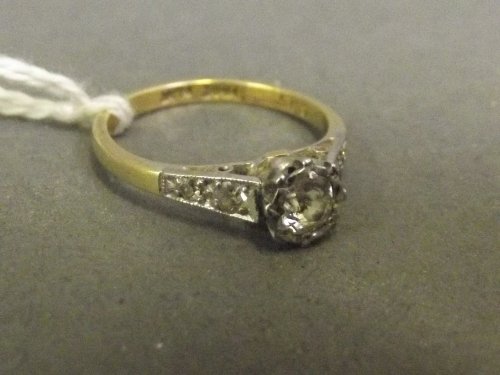 An 18ct gold and platinum ring with a crown set solitai: An 18ct gold and platinum ring with a crown set solitaire diamond, size P