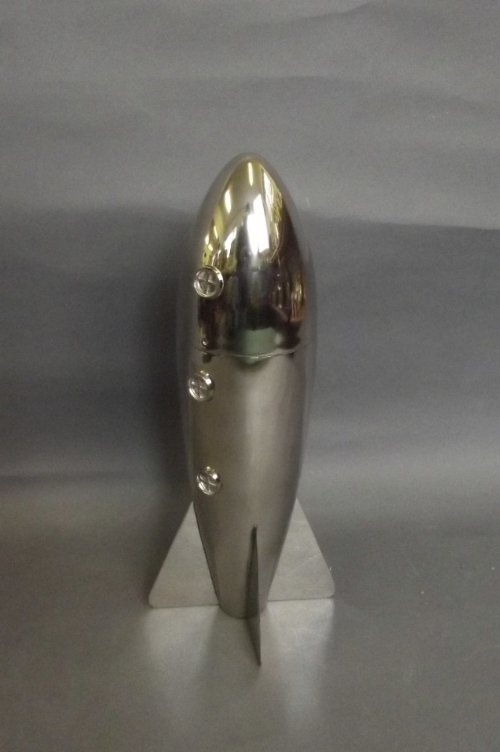 A silver plated cocktail shaker in the form of a rocket: A silver plated cocktail shaker in the form of a rocket, 10¾'' high