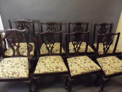 A set of 8 (6 and 2) C18th Irish Chippendale carved wal: A set of 8 (6 and 2) C18th Irish Chippendale carved walnut dining chairs with pierced splat backs and shells carved to the corners, on ball and claw supports