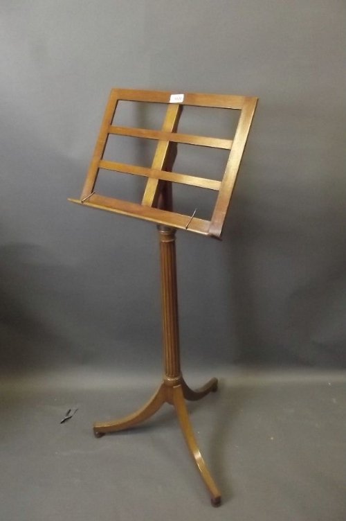 An Edwardian walnut adjustable music stand on a tripod : An Edwardian walnut adjustable music stand on a tripod base, 47'' high