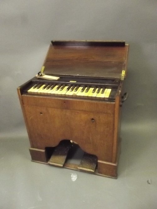 A small late C19th/early C20th portable organ in a rose: A small late C19th/early C20th portable organ in a rosewood case, labelled 'Van Gruisen, Liverpool', 28'' x 12'', 25'' high (bellows AF)