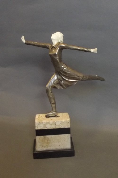 A carved bone and plated metal Art Deco style ice dance: A carved bone and plated metal Art Deco style ice dancer, on rectangular raised base, 14½'' high