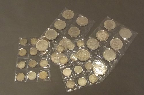 A collection of world coins to include Commonwealth and: A collection of world coins to include Commonwealth and Chinese coins, 1½'' diameter
