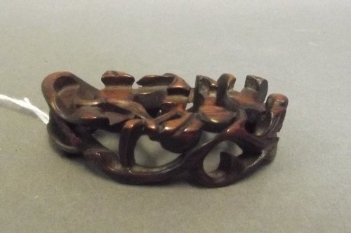 A Chinese carved and pierced hardwood wrist rest, 3'' x: A Chinese carved and pierced hardwood wrist rest, 3'' x 1½''
