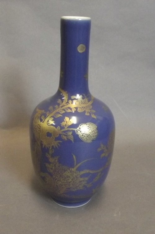 A Chinese blue ground vase with gilt decoration depicti: A Chinese blue ground vase with gilt decoration depicting an exotic bird, seal mark to base, 8½'' high