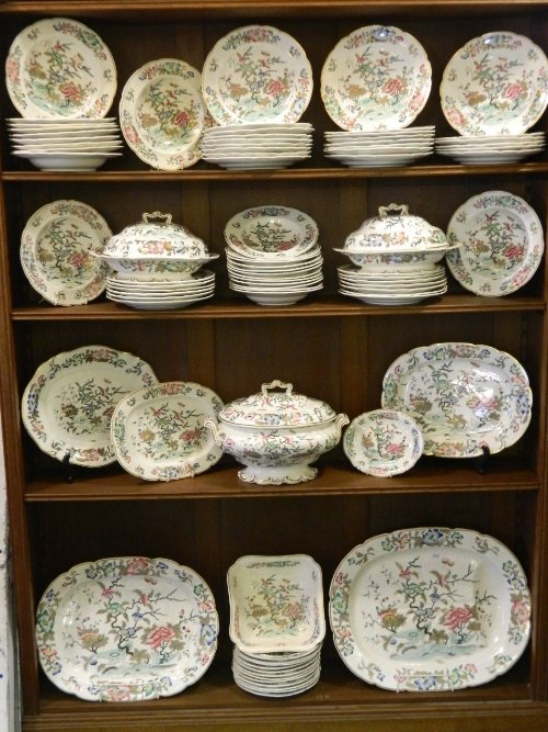 An extensive C19th English dinner service decorated wit: An extensive C19th English dinner service decorated with Oriental style foliage in a Masons style, comprising of large meat plates, tureens, bowls etc