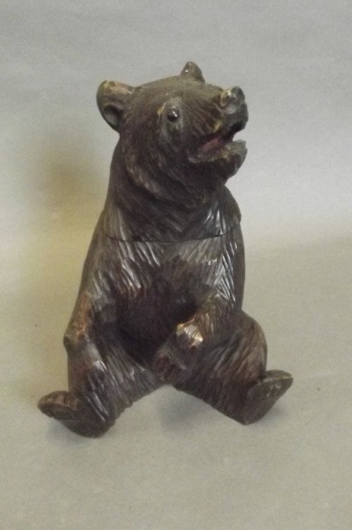 A Black Forest style carved wooden box in the form of a: A Black Forest style carved wooden box in the form of a seated Bear, 8¼'' high