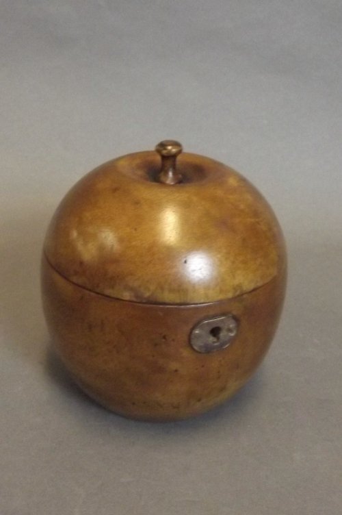 A treen tea caddy in the form of an apple, 4¾'' high: A treen tea caddy in the form of an apple, 4¾'' high