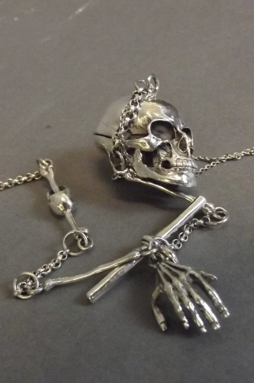A silver watch chain with skull and bone decoration, 12: A silver watch chain with skull and bone decoration, 12¼''