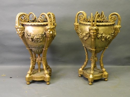 A pair of large gilt bronze jardinières with horned Bac: A pair of large gilt bronze jardinières with horned Bacchus mask grape and vine decoration, standing on hoof supports, 40'' high