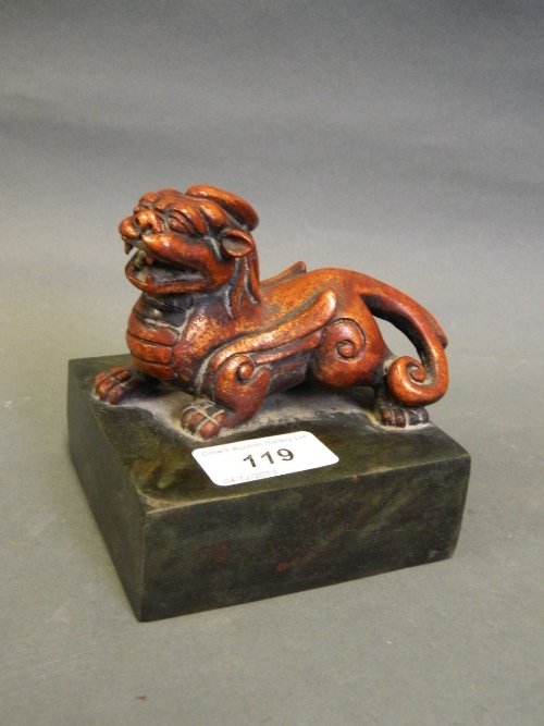 A large Chinese bronze seal surmounted by a gilt bronze: A large Chinese bronze seal surmounted by a gilt bronze kylin, 4'' high